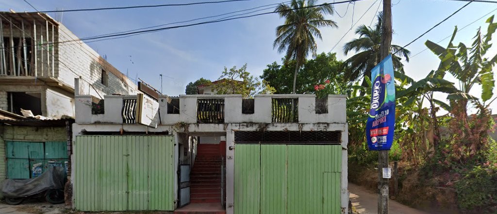 Street view of the clinic entrance with pale green gates