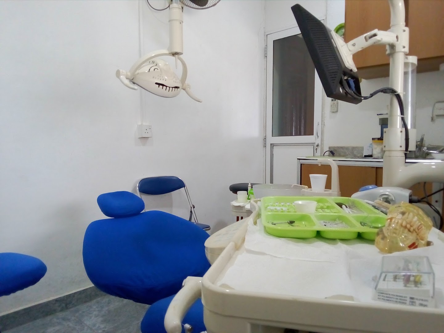 Blue dental chair and treatment equipment in the clinic room