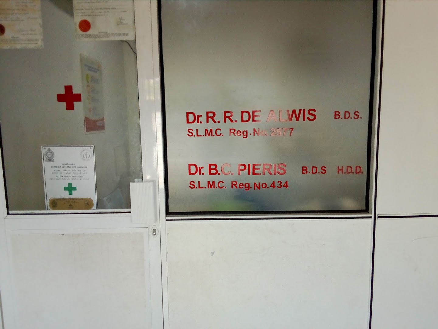 Clinic signage showing named dental clinicians and registration details